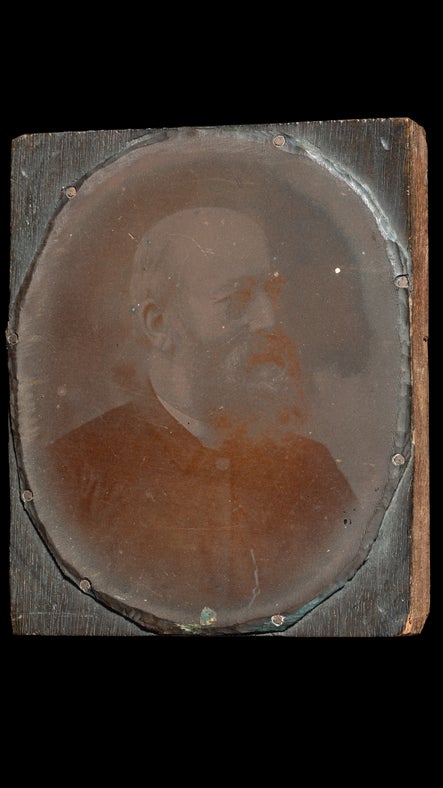A copper plate with a photographic image of the Rev Oswald Reichel.